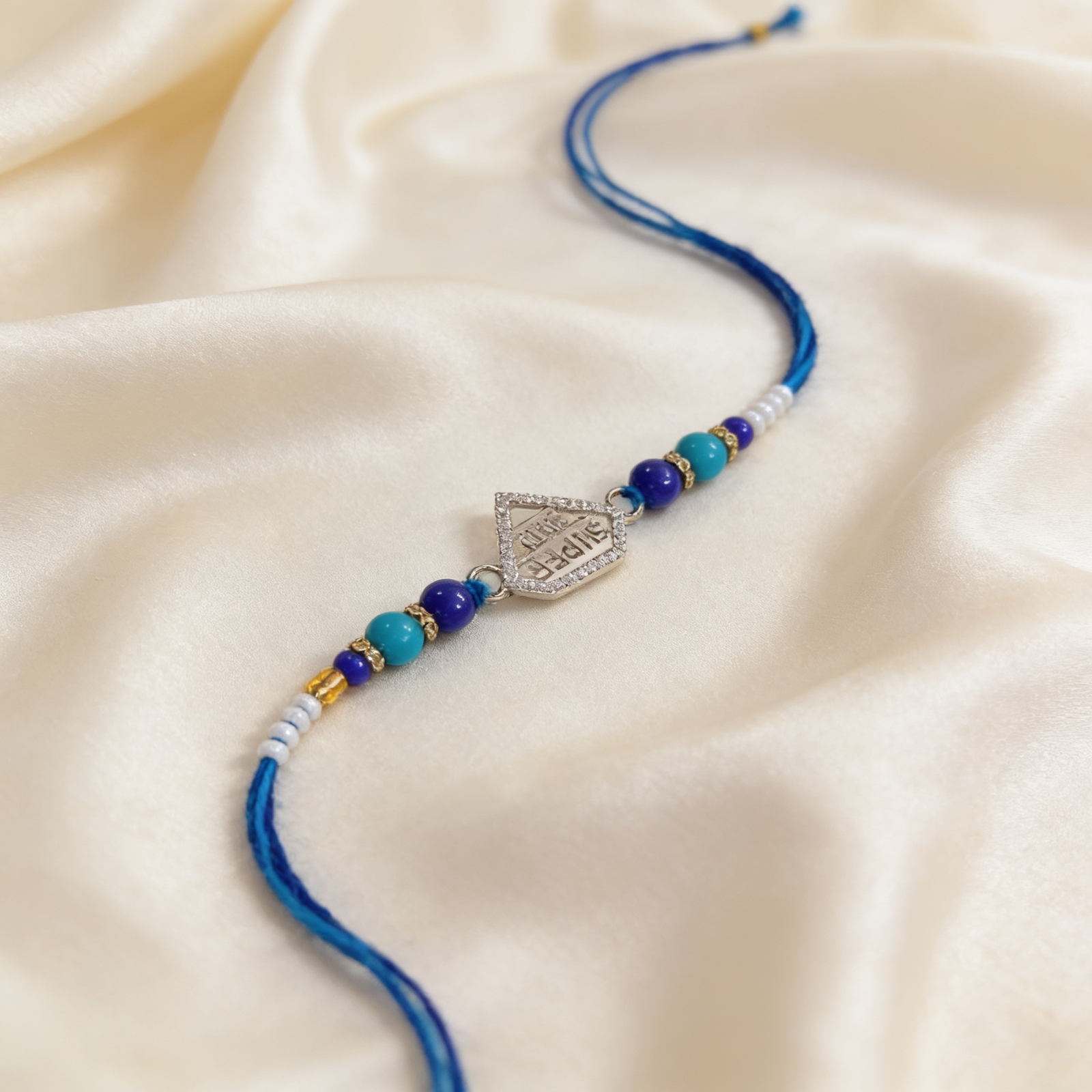 Super Bro rakhi with CZ shield pendant and blue beaded thread - Divine Aura Jewels