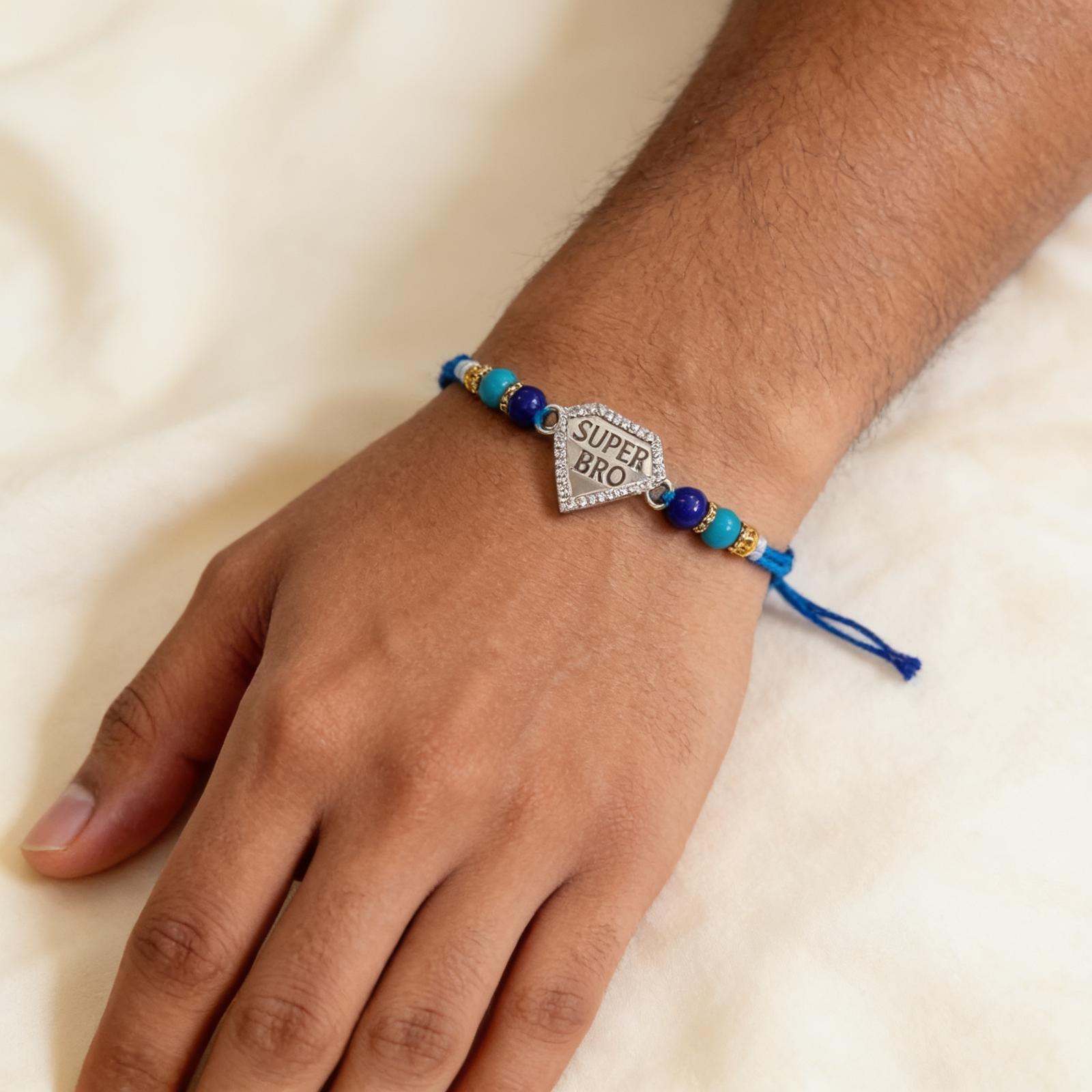 Super Bro CZ shield rakhi worn on wrist